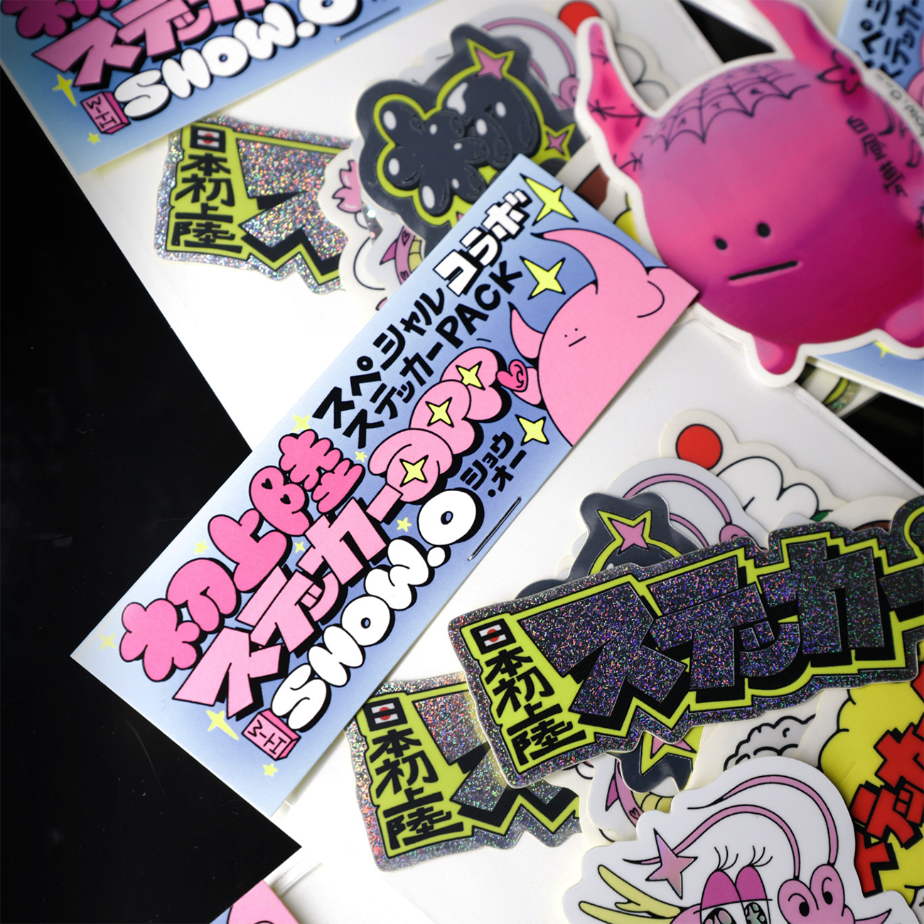 Colorful Japanese cartoon stickers, featuring various characters and text on a glossy surface.