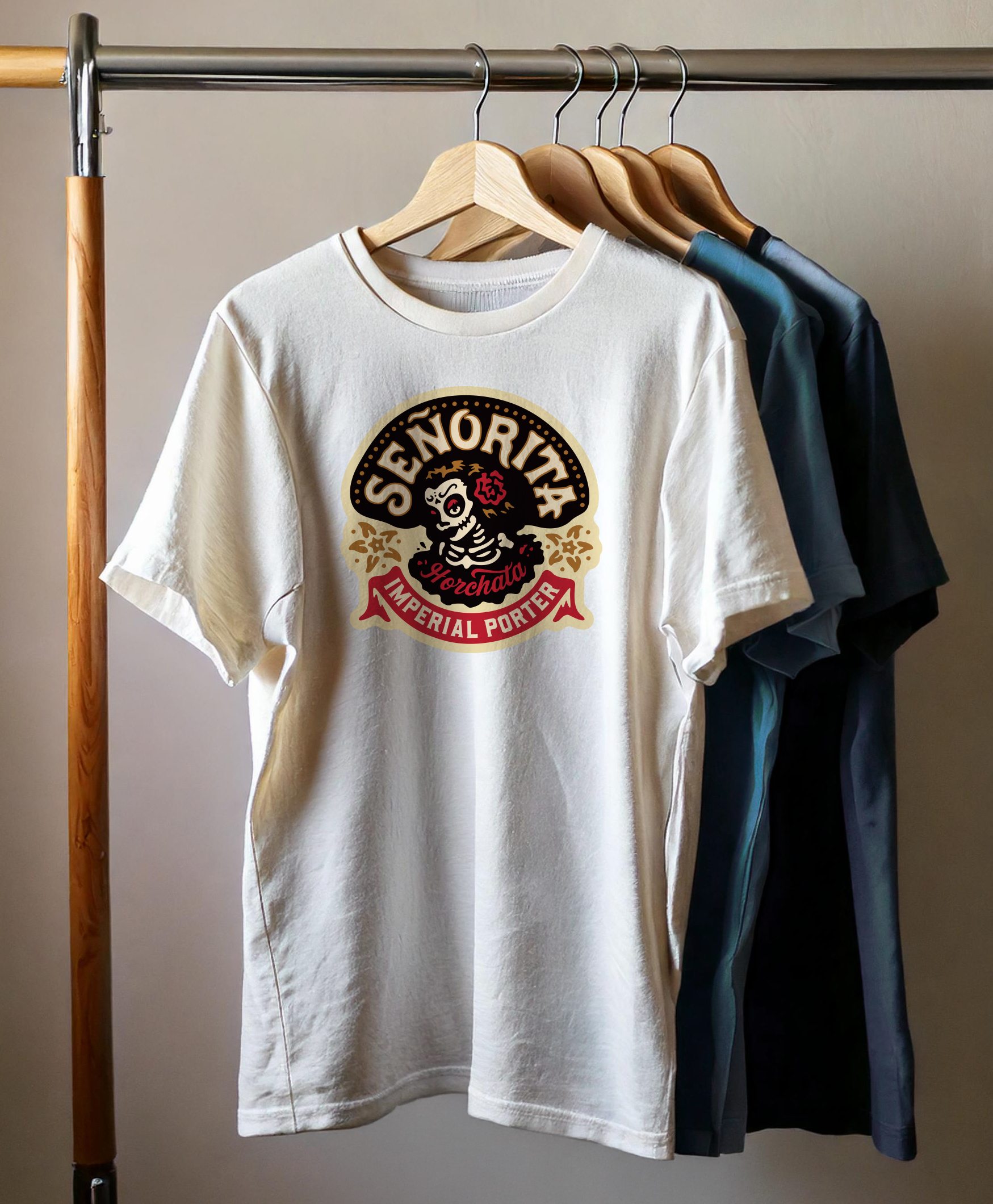 Four t-shirts with custom DTF heat transfers hanging on a rack.