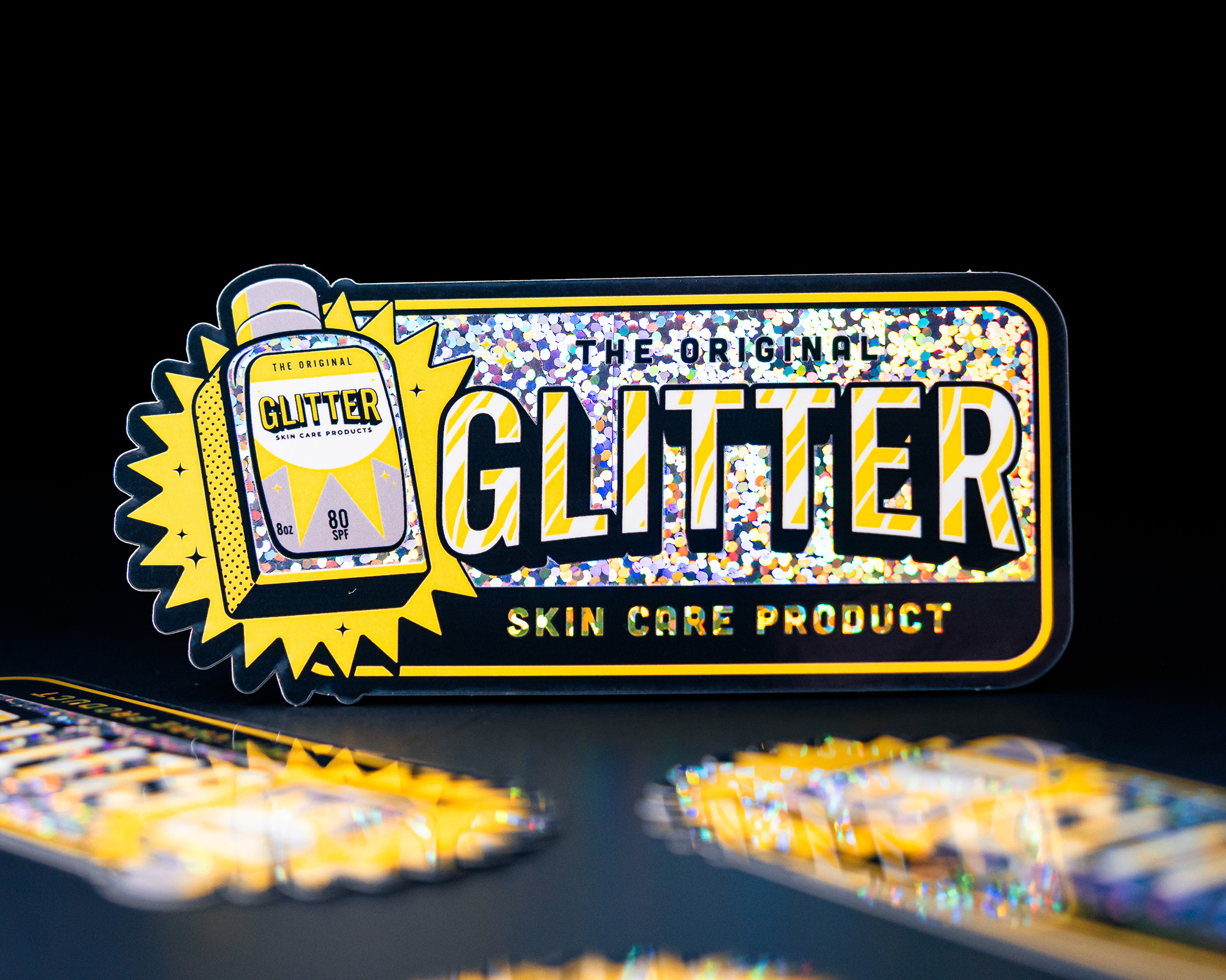 Sticker for "The Original Glitter Skin Care Product" with holographic design and bold text on a dark background.